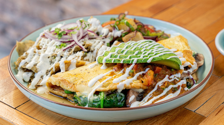 Mexican omelet with chili, avocado, spinach, and onions