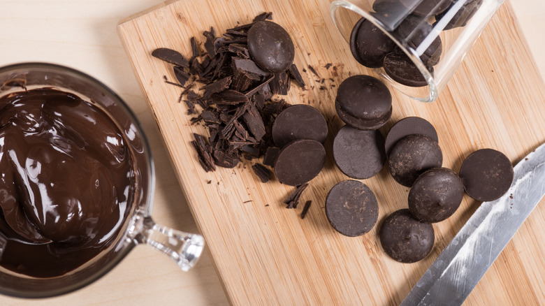 Dark chocolate baking chips displayed on a wooden cutting board