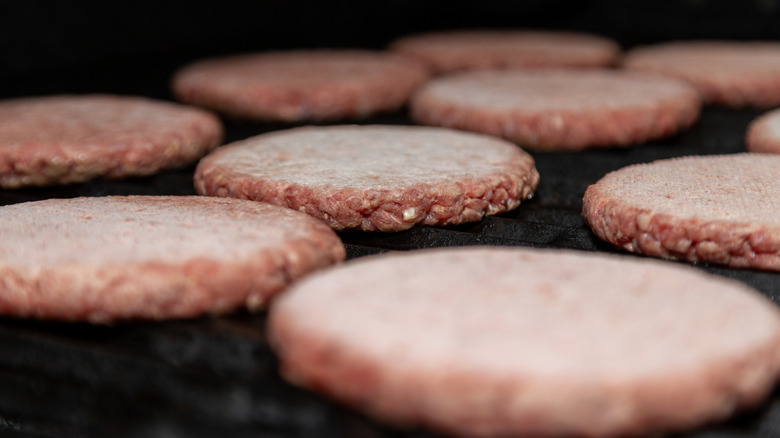 frozen hamburger patties on a grill