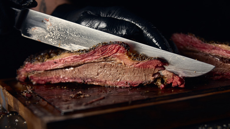 Knife slicing through brisket