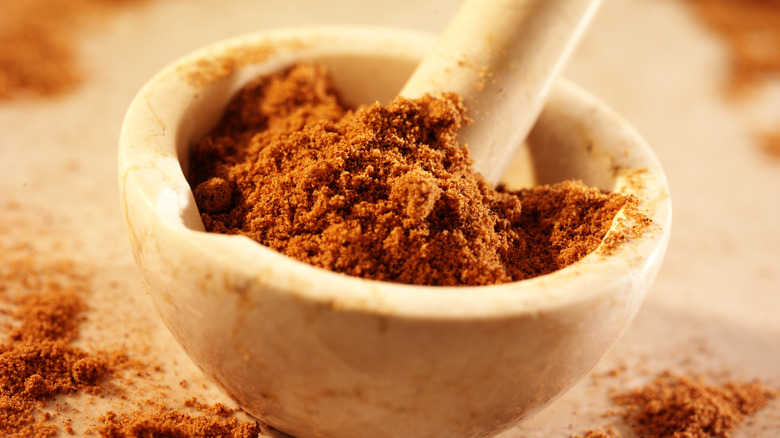 Pestle and mortar with ground nutmeg inside