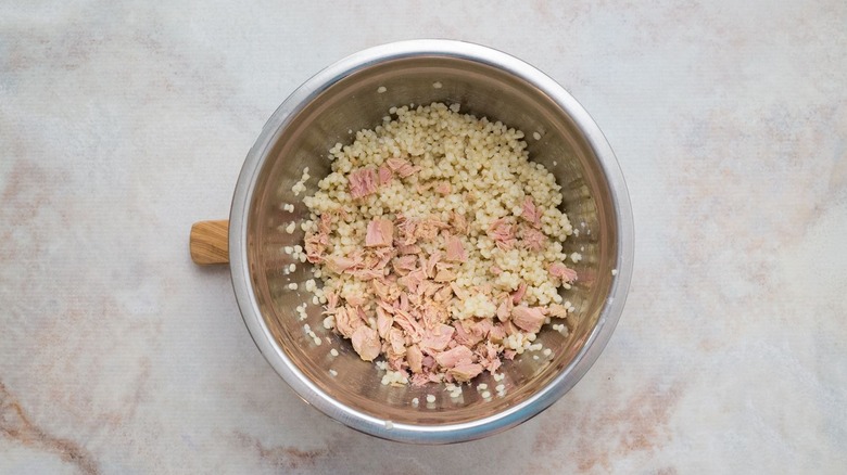 Couscous and canned tuna flakes in bowl