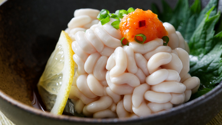 Brain-like substances topped with lemon and orange roe