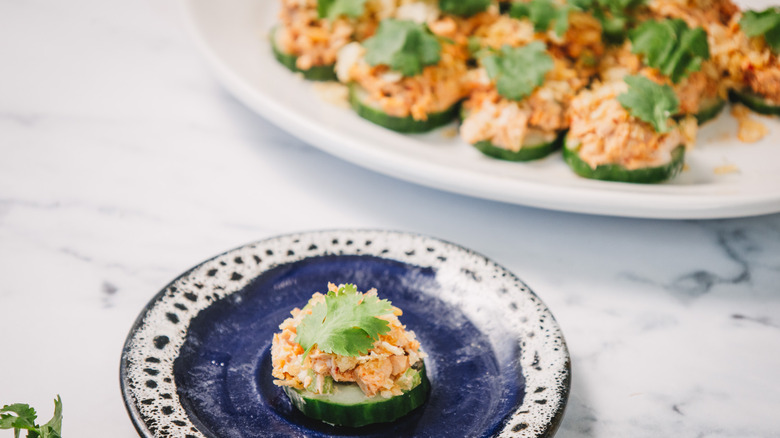 One fricasse tuna salad bite on a plate with more in background
