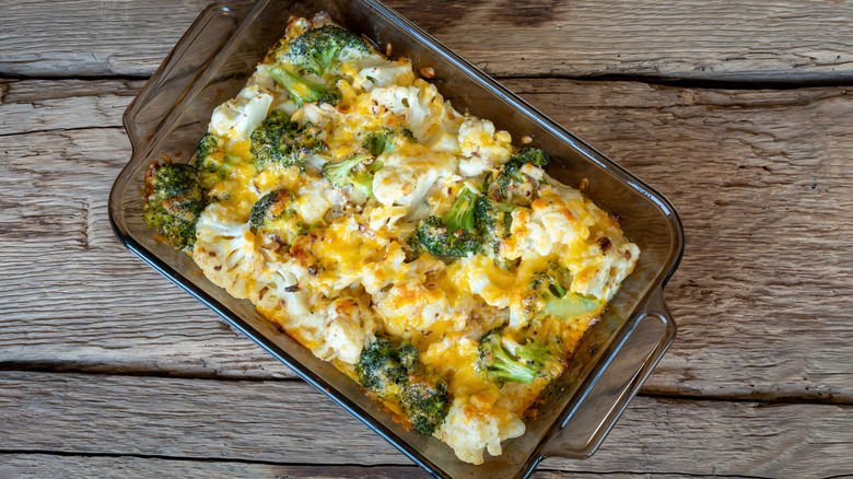 Broccoli topped with cheese in a roasting dish