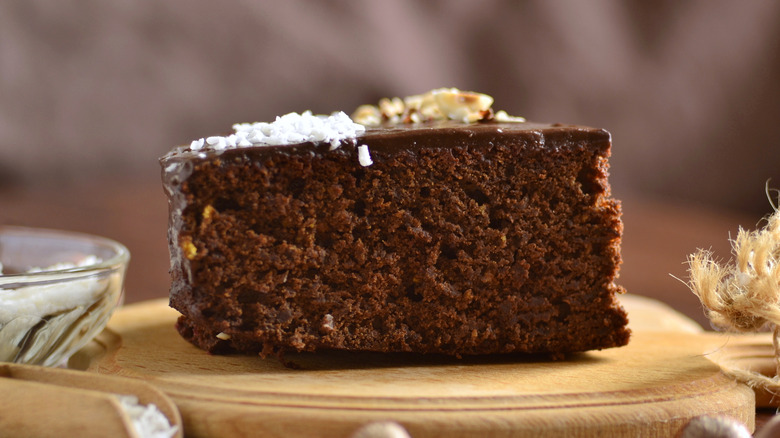 a slice of chocolate beetroot cake with hazelnut topping