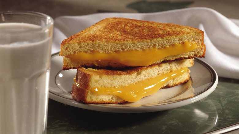 Grilled cheese halves with milk