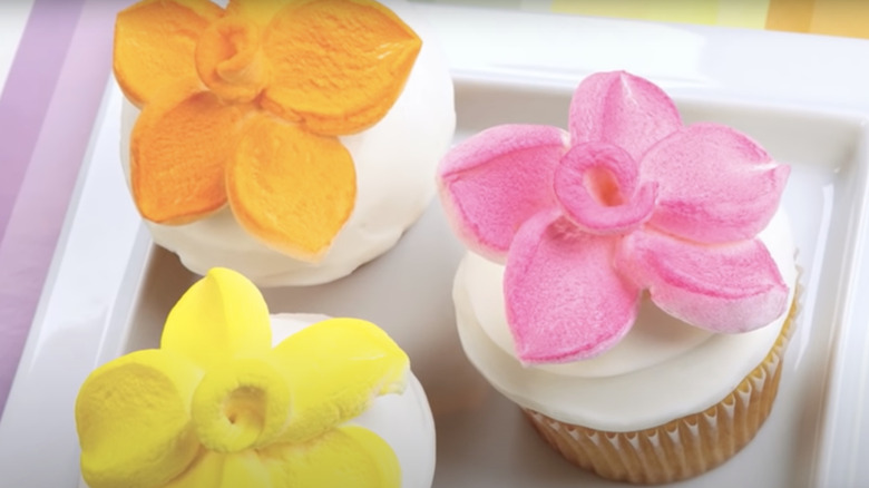 painted flower marshmallows on cupcakes