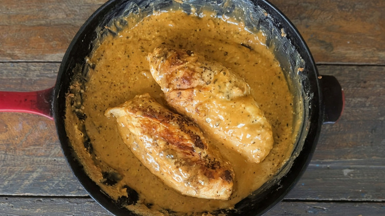 Creamy pepper jelly chicken breasts in cast iron skillet