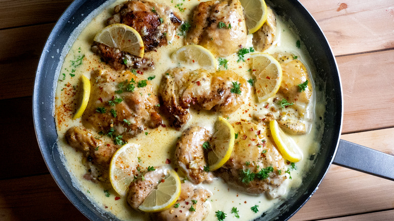 chicken in pan with lemon sauce