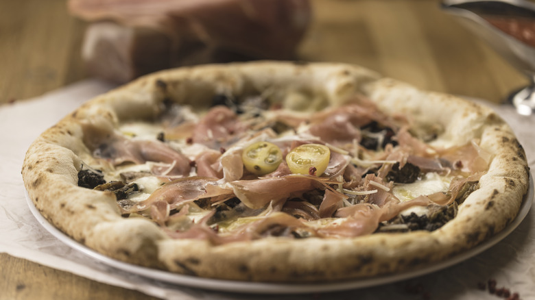 Gourmet pizza topped with cured meats