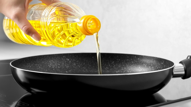 oil drizzling in a pan