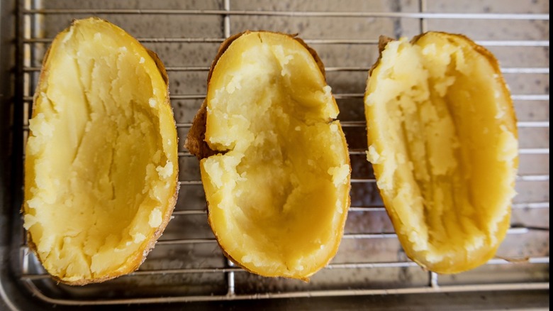 Empty cooked potato skins on a rack
