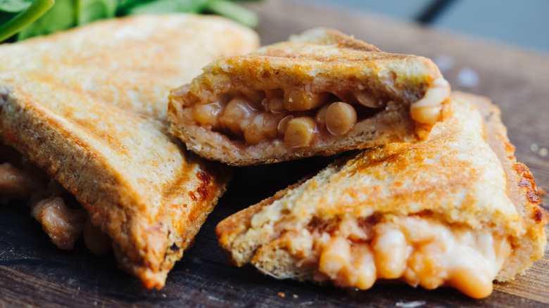 baked bean toastie on wood board