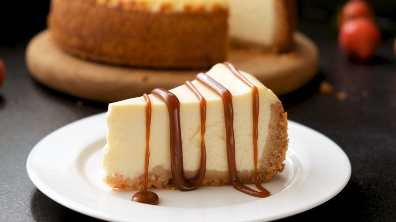 Cheesecake on a white plate with a caramel drizzle
