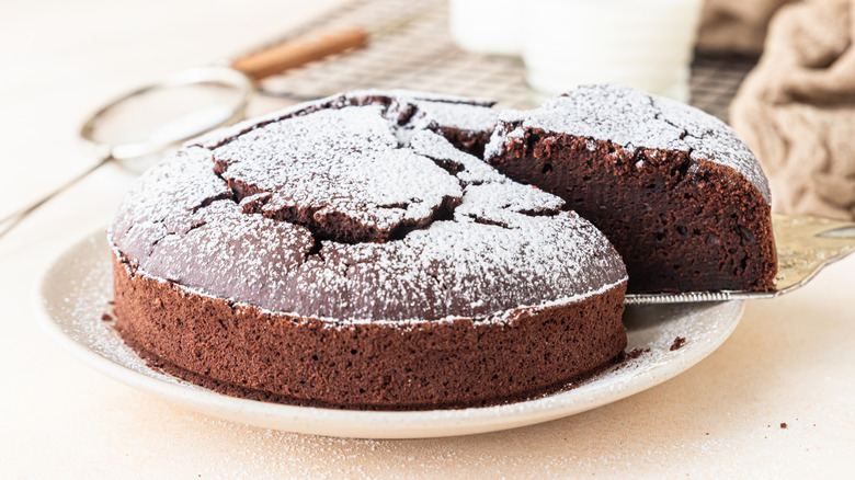 Flourless chocolate cake slice being cut