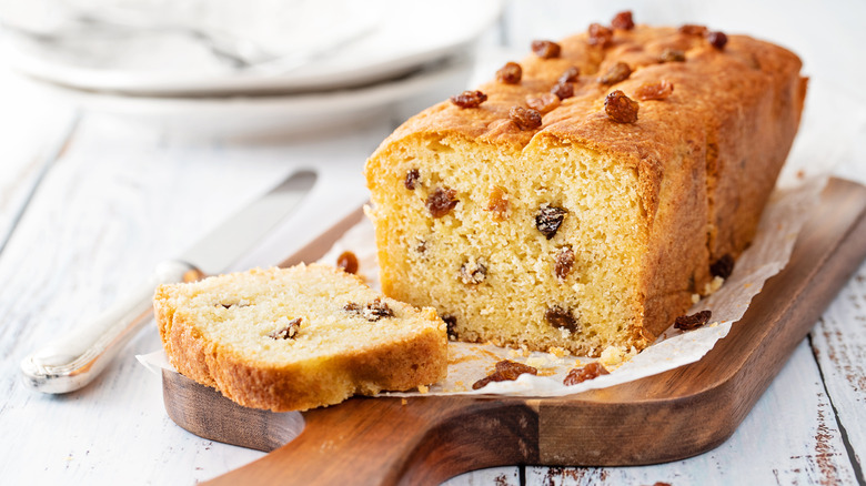 Loaf of fruitcake on a wooden board