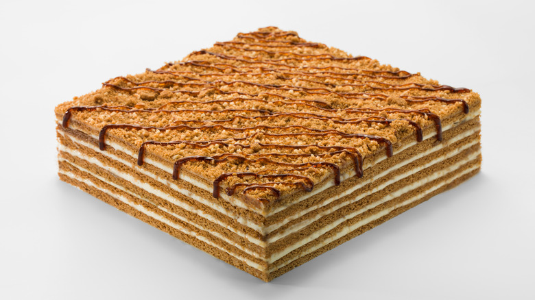 Square honey cake against a white background