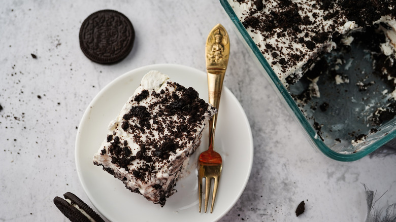 Icebox cake slice on a white plate with a fork