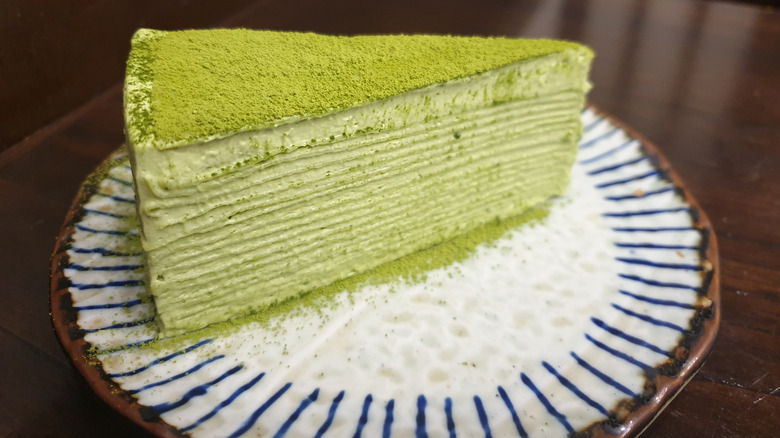 Matcha mille crepe cake slice on a decorative plate