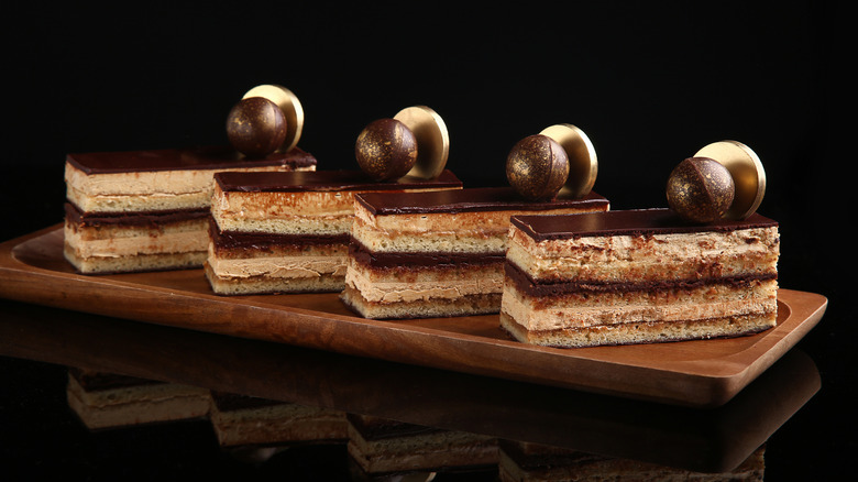 Opera cake slices on a wooden tray