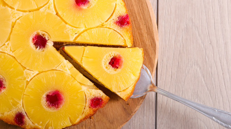 Pineapple upside-down cake slice being cut