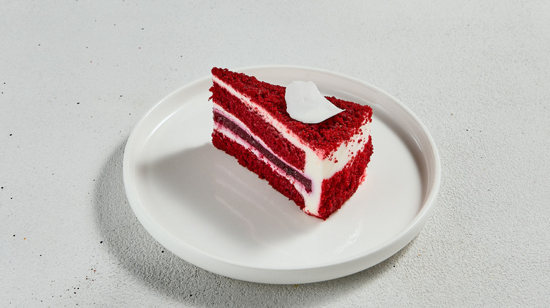Red velvet cake slice on a white tray