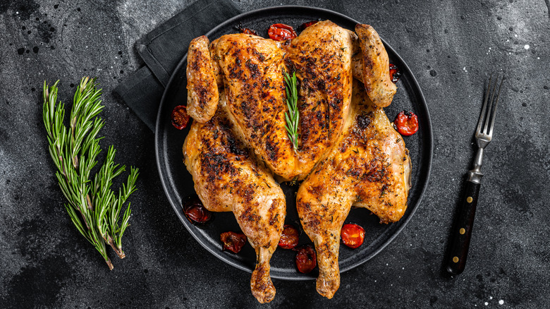 Plated whole roast chicken with rosemary