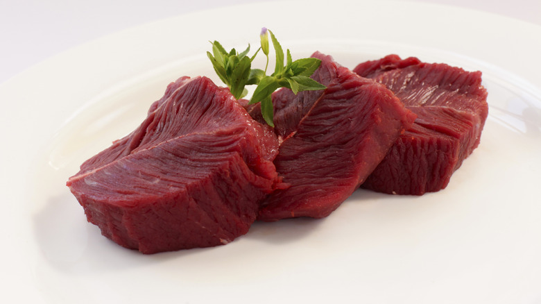 Ostrich filets on white plate