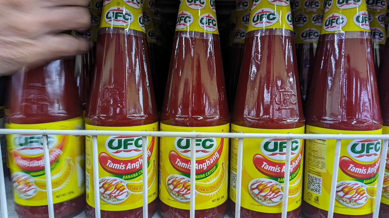 Bottles of banana ketchup with hand reaching for one