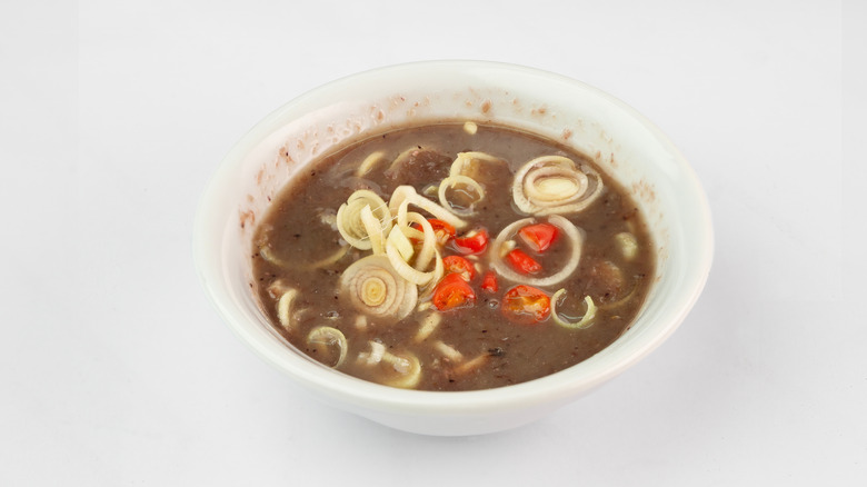 Bowl of Vietnamese mắm tôm with scallions and chiles