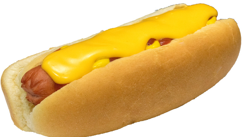 Hot dog topped with cheese sauce