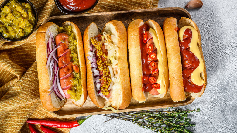 Hot dogs in serving tray with various toppings