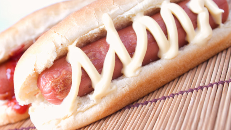 Hot dog topped with mayonnaise