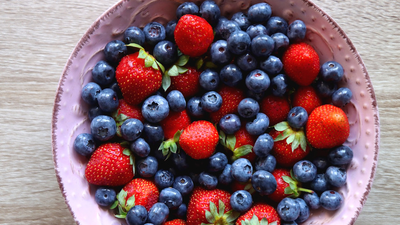 A large bowl of strawberries and blueberries