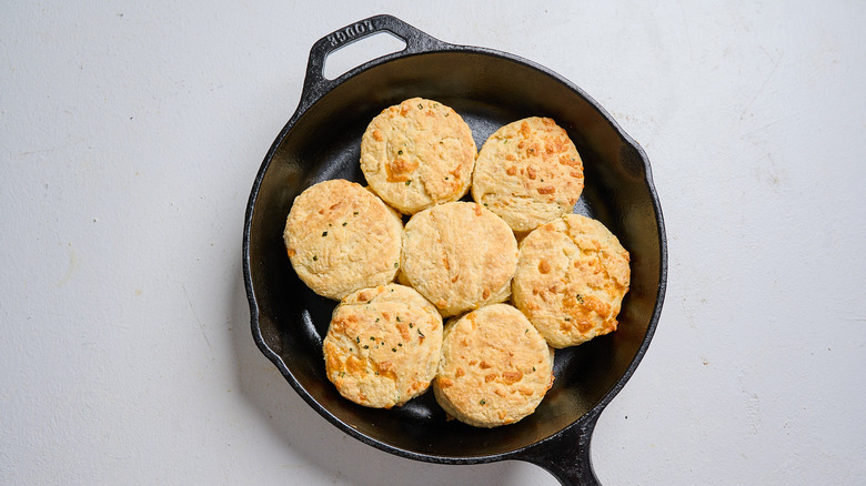 golden brown baked biscuits in a cast iron