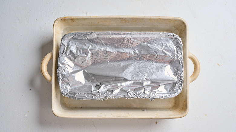 Loaf pan covered in foil