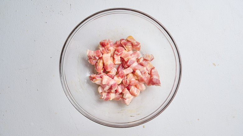 tossing pork belly strips with honey