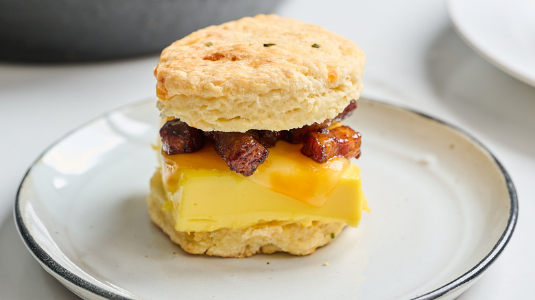 bacon, egg, and cheese biscuit on a table