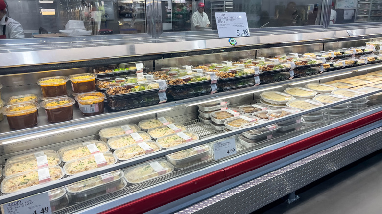 The deli section of a Costco warehouse, featuring an array of prepared meals