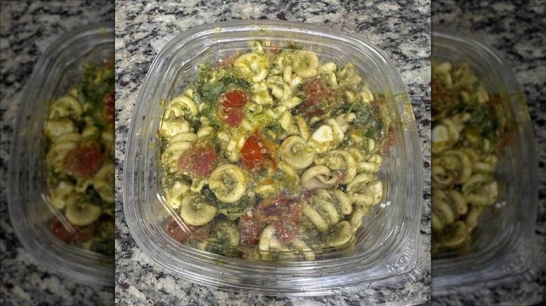 A package of Costco's pre-made pesto pasta salad on a kitchen counter
