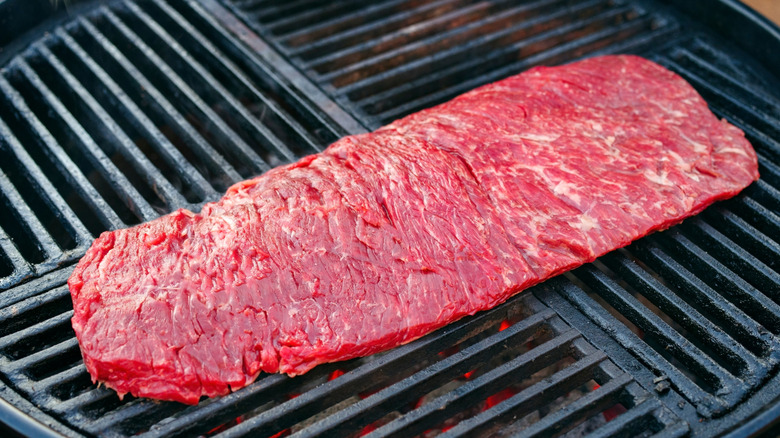 Raw bavette steak on grill