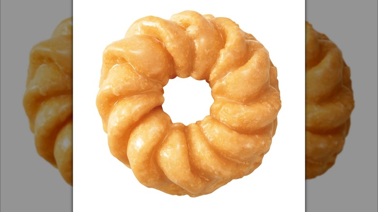 Dunkin' cruller donut on pink background