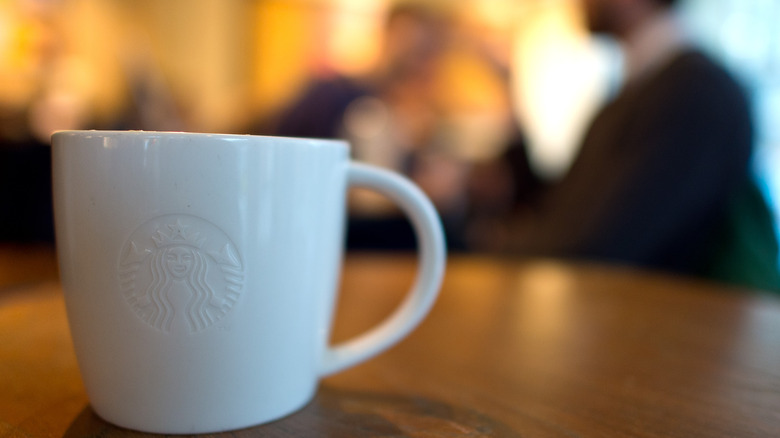 white Starbucks mug on table
