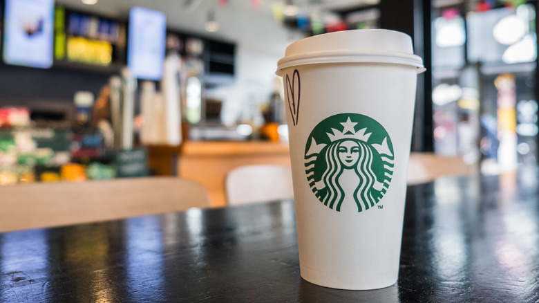 hot drink in paper cup at Starbucks