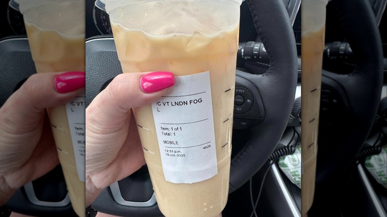 customer holding Starbucks iced latte