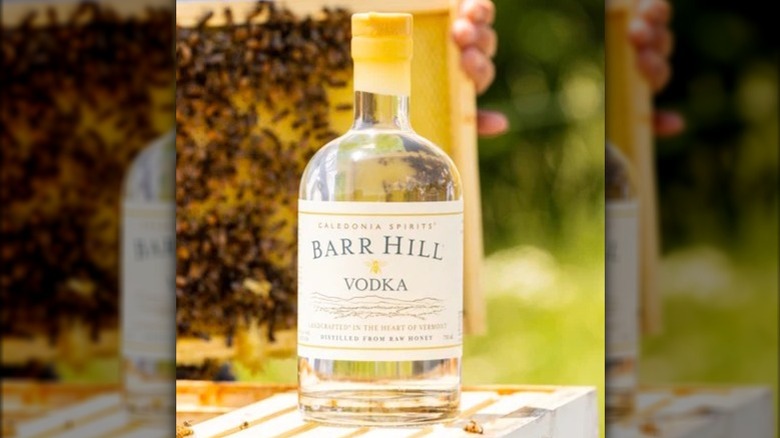 Bottle of Barr Hill Vodka with honeycomb in the background