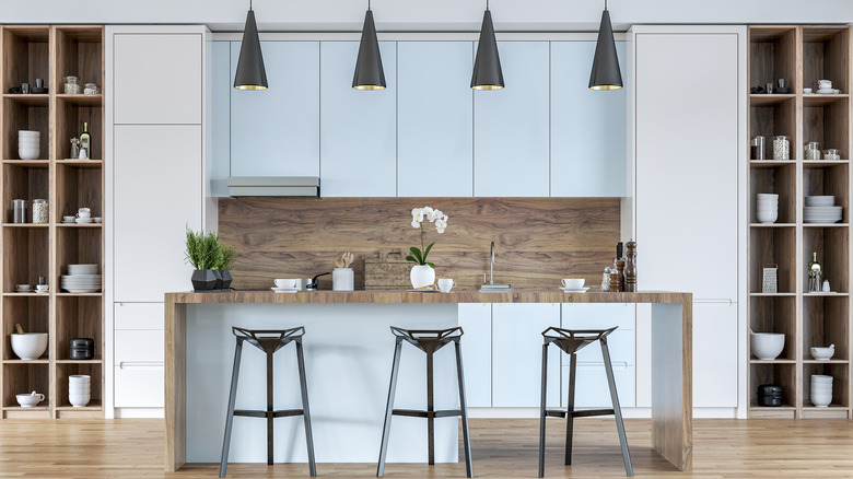Modern kitchen with light blue cabinets and wooden open shelves