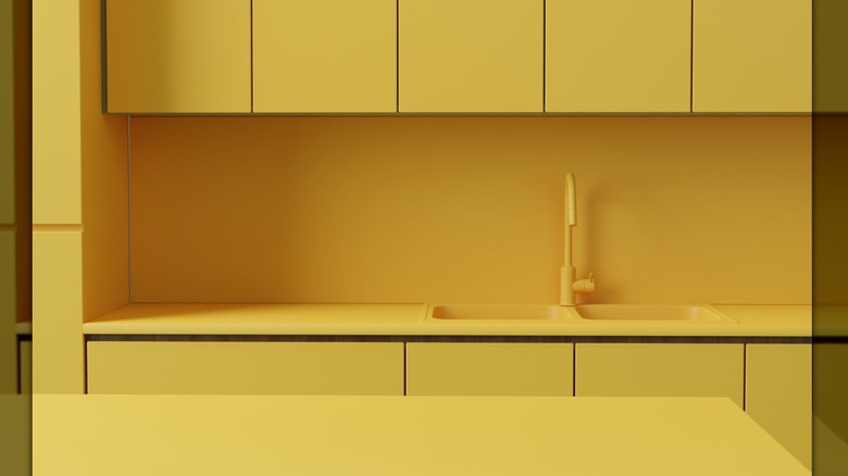 Fully lemon-colored kitchen with cabinets, backsplash, and faucet all in the same color