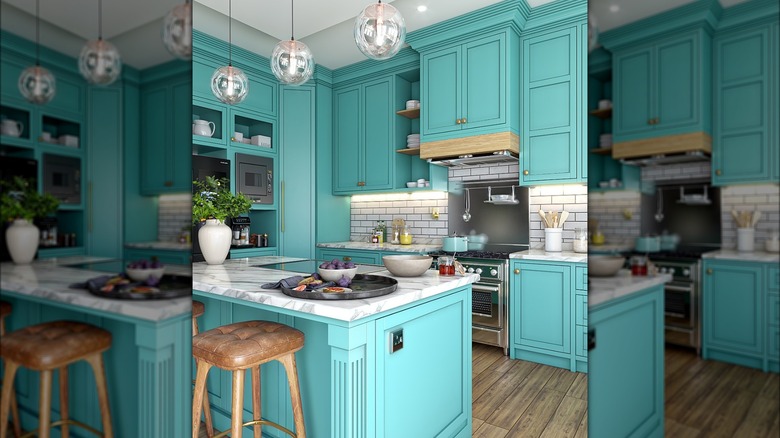 Kitchen with turquoise cabinets and an island, with marble countertops